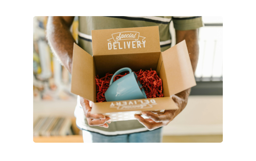 Special delivery box with a blue mug and red filler, showcasing visual content for eCommerce branding.